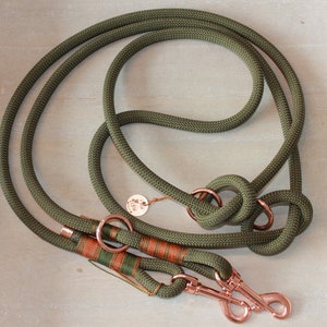 May include: A green double-ended dog leash with copper hardware. The leash has a knotted design and two clips.