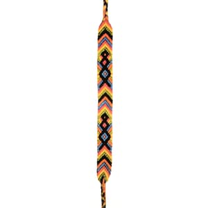 May include: A single shoelace with a colorful geometric pattern. The design features a repeating pattern of black, yellow, orange, blue, and pink chevrons and diamond shapes. The shoelace is against a white background.