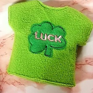 May include: Green felt t-shirt with a green shamrock and the word "LUCK" embroidered on it.