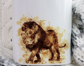 May include: White ceramic mug with a brown lion illustration in a coffee stain style. The lion is walking to the right and has a mane. The mug is sitting on a white and gray knitted blanket.