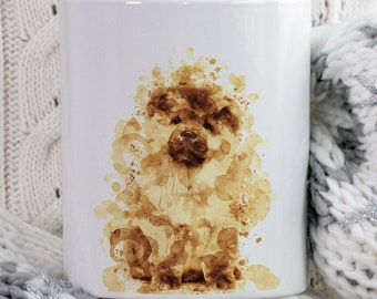 May include: White ceramic mug featuring a brown watercolor-style illustration of a dog. The dog illustration is made of coffee stains. The mug is resting on a white and gray knitted blanket. The mug has the words "BEANY BEANY" in a brown circle.