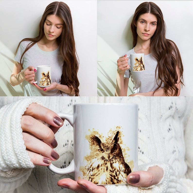 May include: White ceramic mug featuring a watercolor-style illustration of an owl in shades of brown and beige. The owl's detailed eyes and feathers are prominent. The mug is held by a person.