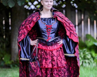 5 pc. Pirate or Vampire costume. Cloak, full skirt, peasant blouse, bodice laced vest and satchel. Color changing red sateen cloak/skirt.