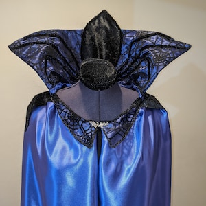 Purple satin full length cloak with an outstanding and large, black spider on a sparkling web collar.  Leaf hook and eye closure.
