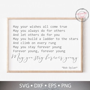 May include: A framed print with the Bob Dylan quote "May you stay forever young" in black script. The quote is on a white background, framed by a light brown wooden frame. The bottom of the frame has the file types SVG, DXF, EPS, and PNG.