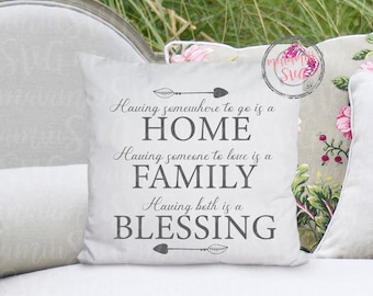 May include: A white decorative pillow with the text "Having somewhere to go is a HOME, Having someone to love is a FAMILY, Having both is a BLESSING" in gray. The pillow is on a light-colored sofa with floral pillows.