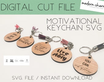 May include: Five wooden keychains with different motivational phrases engraved on them. The keychains are attached to silver key rings with colorful tassels. The phrases are "You got this!", "You are beautiful", "Stronger than the storm", "Live your story", and "You can. End of story."