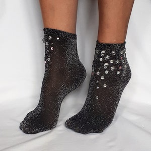May include: A pair of black sparkly socks with silver and pink rhinestones.