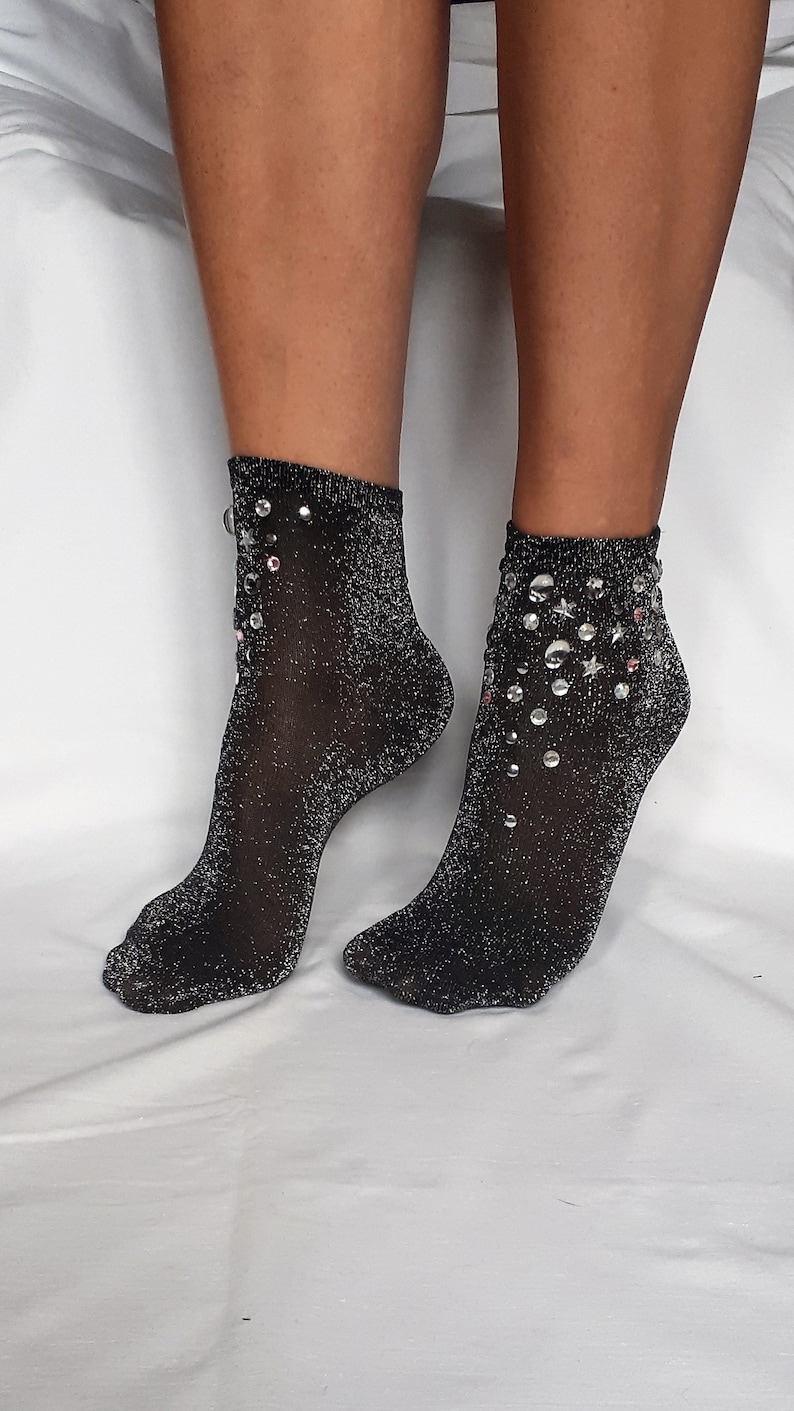 May include: A pair of black sparkly socks with silver and pink rhinestones.