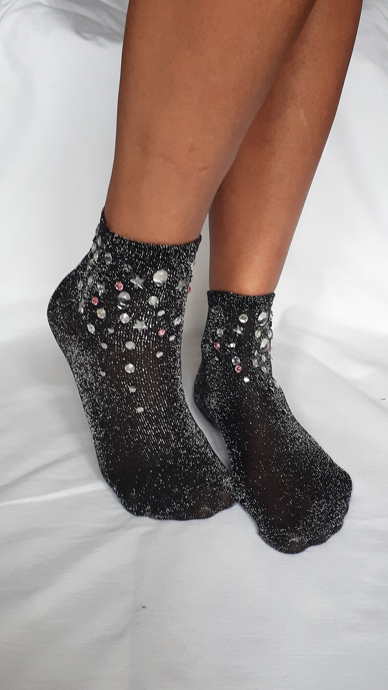 May include: A pair of black sparkly ankle socks with silver glitter and rhinestones.