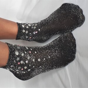 May include: A pair of black sparkly ankle socks with silver and pink embellishments.