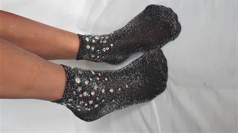 May include: A pair of black sparkly ankle socks with silver and pink embellishments.