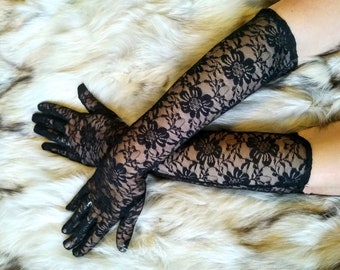 May include: A pair of black lace gloves with a floral pattern. The gloves are long and extend past the elbows.