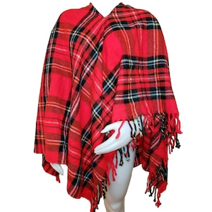 May include: Red and black plaid poncho with fringe trim.