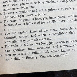 May include: Close-up of a printed page with inspirational text. The text includes phrases about living life, joy, and the fruits of old age. The paper is off-white with black text.