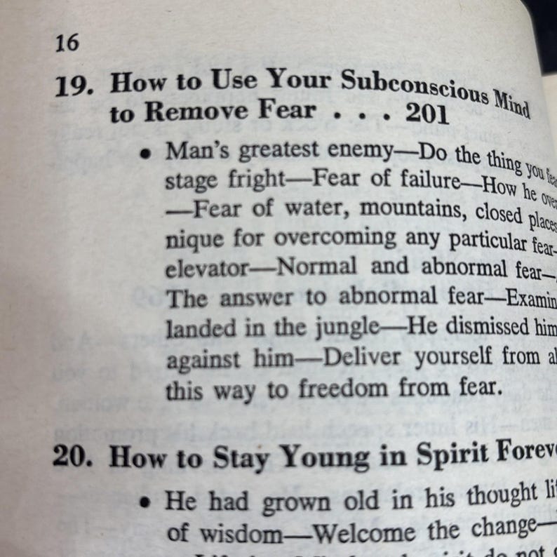 May include: Open book page with text: "How to Use Your Subconscious Mind to Remove Fear." The text is in black ink on aged, off-white paper. The page number "16" is visible at the top left.