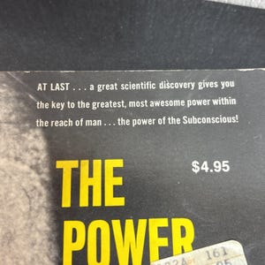 May include: A book cover with the title "THE POWER" in large yellow letters. The text "AT LAST... a great scientific discovery gives you the key to the greatest, most awesome power within the reach of man... the power of the Subconscious!" is also visible.