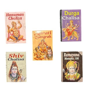 May include: A collection of small, colorful books with religious themes. The covers feature illustrations of deities and text in various fonts. Titles include "Hanuman Chalisa," "Durga Chalisa," and "Ramayana Manaka 108."
