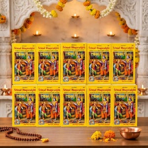 May include: Ten identical copies of the Srimad Bhagavadgita book arranged in two rows. Each yellow cover features a colorful illustration of two figures, one standing and one kneeling, with text in English and Sanskrit script printed on the front.