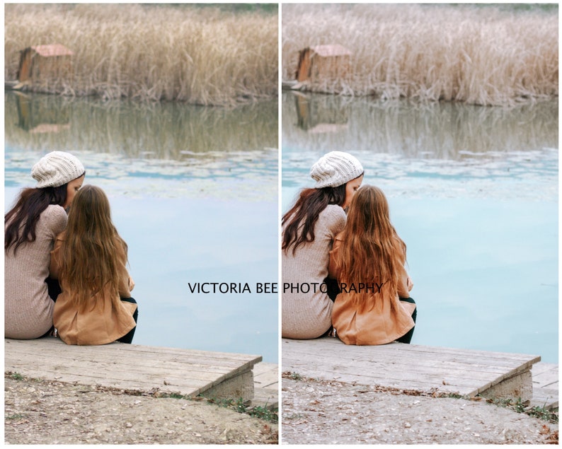 May include: Two people, a mother and daughter, are sitting on a wooden dock by a lake. They are wearing winter clothing, including hats and coats. The lake is calm and the water is a light blue color. The background is a blurry image of trees and reeds.