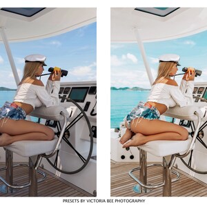May include: A woman wearing a white shirt and denim shorts sits on a white stool on a boat. She is holding binoculars and looking out at the ocean.
