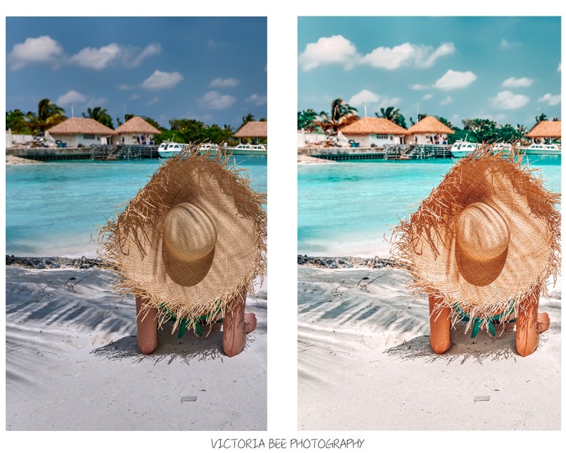 May include: A woman wearing a large, brown straw hat sits on a white sandy beach with turquoise water in the background.  The beach is in front of a tropical island with several buildings.