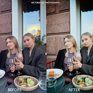 May include: Two people are sitting at a table outside a restaurant. They are both wearing blazers and have glasses of wine in front of them. There is a plate of food in front of each person. The text "VICTORIA BEE PHOTOGRAPHY" is visible in the top center of the image.