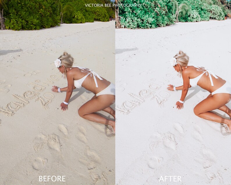 May include: A woman in a white bikini is kneeling on a white sandy beach. She is writing "Hello 2023" in the sand. The beach is surrounded by lush green trees.