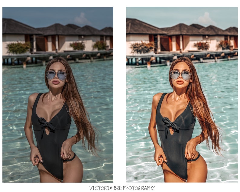 May include: A woman wearing a black one-piece swimsuit with a bow detail and sunglasses, standing in a pool of water. The background features a tropical resort with palm trees and buildings.