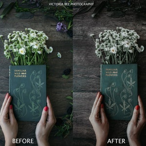 May include: A vintage green book titled "Familiar Wild Flowers" with gold lettering, held by hands against a dark wood background with white flowers.
