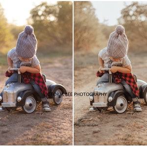 May include: A young child wearing a gray knitted hat with a pom-pom sits in a gray toy car with a red and black plaid blanket draped over the back. The child is looking down at the steering wheel. The car is on a dirt path with trees in the background.