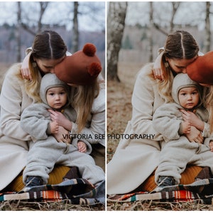 May include: Two people are sitting on a blanket in a forest. One person is wearing a brown hat with pom-poms and is kissing a child on the head. The child is wearing a gray hooded jumpsuit. The text "VICTORIA BEE PHOTOGRAPHY" is visible in the image.