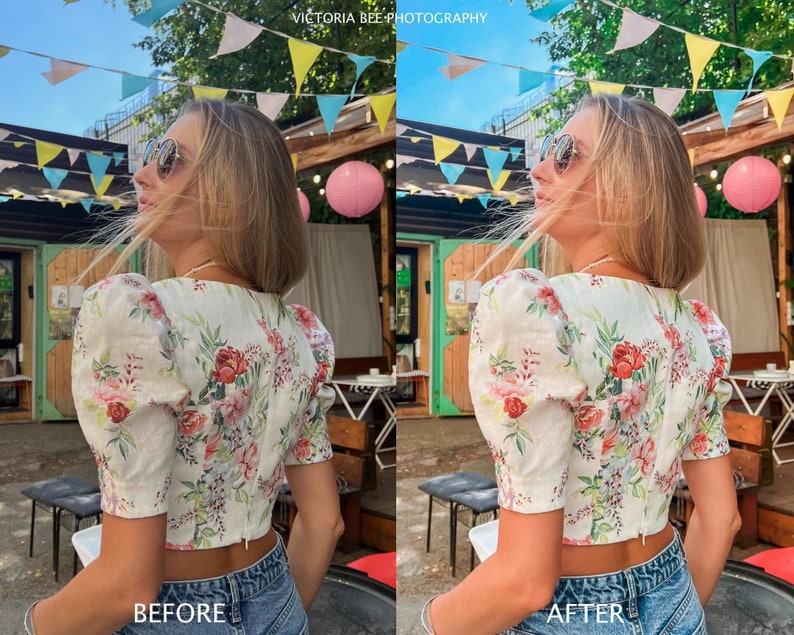 May include: A woman wearing a white floral print crop top with puff sleeves and blue jeans. She is standing outdoors with a string of colorful flags hanging overhead.