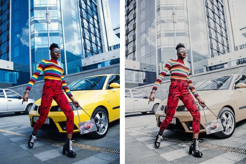 May include: A person wearing a rainbow striped sweater, red pants with a floral pattern, and black boots is walking down a city street. They are carrying a floral patterned handbag. A yellow car is parked behind them.
