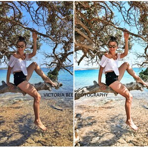 May include: A woman wearing a white off-the-shoulder top, black denim shorts, and sunglasses sits on a tree branch over a body of water. The water is a light blue color and the sky is a bright blue. The text "VICTORIA BEE PHOTOGRAPHY" is visible in the bottom left corner of the image.