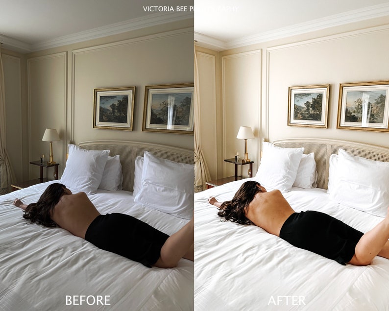 May include: A woman lies on a white bed with white pillows and a white bedspread. The bed is in a room with beige walls and two framed landscape paintings on the wall. The woman is wearing a black skirt and has long dark hair.