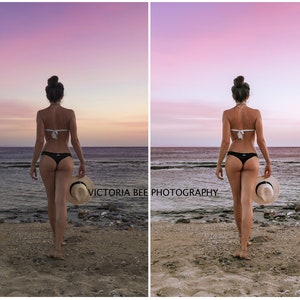 May include: A woman in a black bikini walks along a sandy beach with a straw hat in her hand. The sky is a vibrant pink and purple, creating a beautiful sunset backdrop.