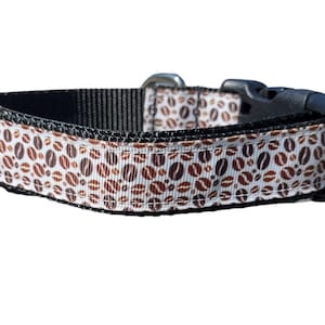 May include: A black dog collar with a white and brown coffee bean pattern.