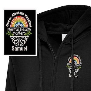 May include: Black zip-up hoodie with a white embroidered design featuring a rainbow brain, the text "Queen Elizabeth Hospital", "Mental Health Matters", and the name "Samuel".