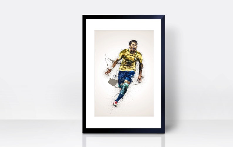 May include: A framed print of a soccer player in a yellow and blue uniform, running and celebrating a goal. The player is in mid-air, with a dynamic pose and a determined expression on his face. The background is a white canvas with splashes of paint.