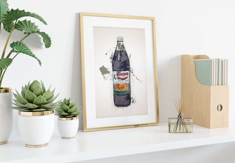May include: A framed print of a vintage-style illustration of a glass bottle of "Black's" soda. The bottle is purple and green with white text and a red logo. The background is a light beige with splatters of paint.