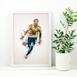 May include: A framed print of a soccer player in a yellow and blue uniform, running with the ball, against a white background with paint splatters.