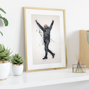 May include: A framed print of a black and white illustration of a person with arms raised in the air, standing on a white background with black paint splatters.