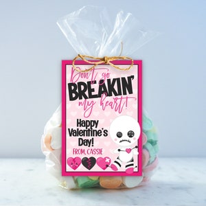 May include: Pink and black Valentine's Day gift tag with a cute cartoon doll and the text "Don't go breakin' my heart! Happy Valentine's Day! From, Cassie".