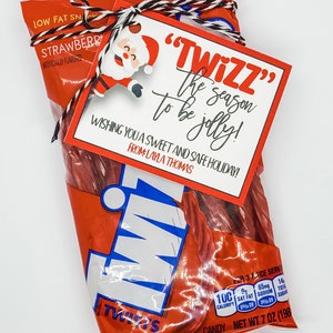May include: A red and white bag of Twizzlers strawberry licorice twists with a red and white gift tag that says "Twizz the season to be jolly! Wishing you a sweet and safe holiday! From Layla Thomas."