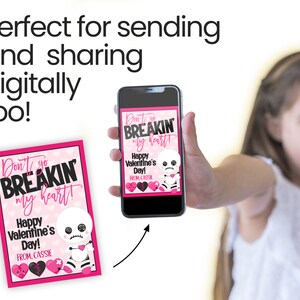 May include: A pink and black Valentine's Day card with a skeleton holding a broken heart. The card says "Don't go BREAKIN my heart!" and "Happy Valentine's Day!" with a personalized message "FROM, CASSIE".