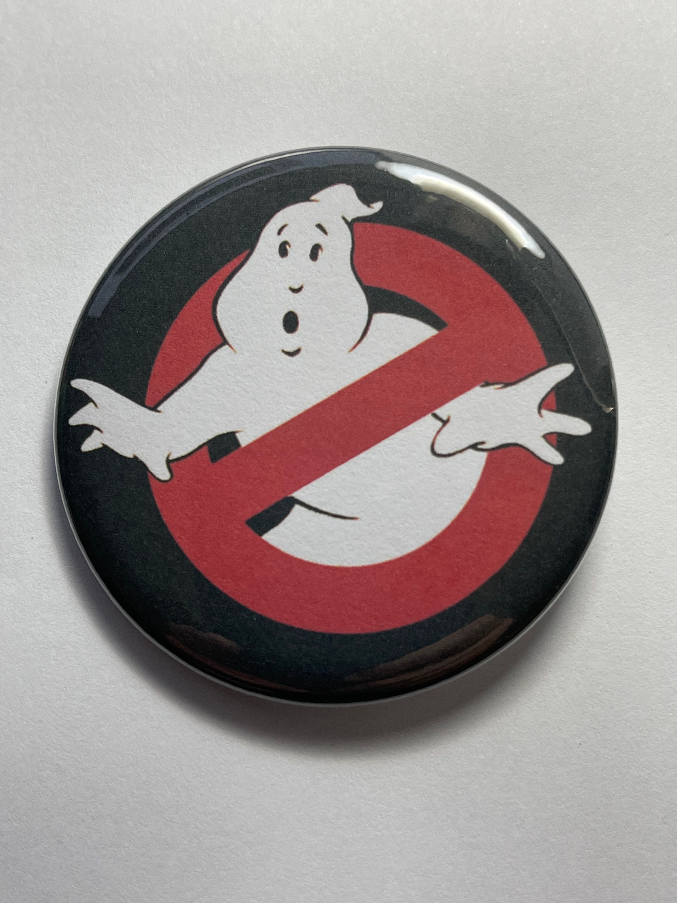 Ghostbusters! Magnets or pin back buttons. The logo from the first ghost busters movie.