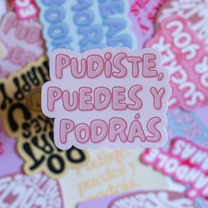 May include: Pink and white sticker with the text "Pudiste, Puedes y Podrás" in a bold, rounded font.