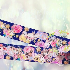 May include: A blue ribbon with a repeating pattern of tooth fairies, flowers, and gold glitter. The tooth fairies are wearing pink and white dresses and have wings. The text "Magical Forest" is visible on the ribbon.