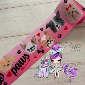 May include: Pink ribbon with illustrations of dogs, paw prints, and hearts. The word "paws" is written in a script font with an arrow. Additional illustrations include a unicorn, a fairy, and a dragon.
